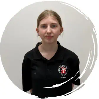 Young girl in black Monkey Puzzle Astwick uniform smiling at camera.